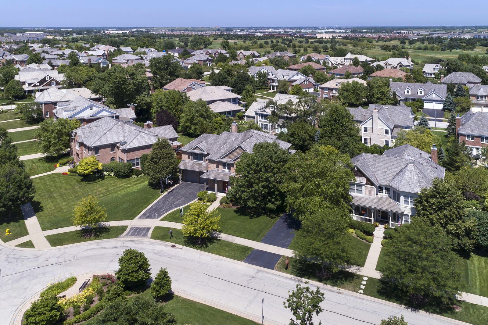 Aerial view of a suburban Illinois street of two-story houses with new roofs